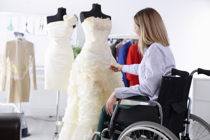 A person in a wheelchair looking at a wedding dress

AI-generated content may be incorrect.